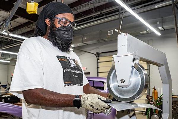 Minority student within auto restoration class